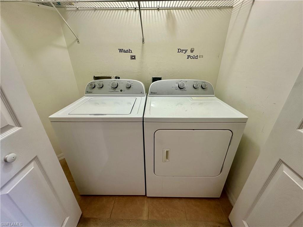 996 Hampton Circle, Unit 71 Naples, FL 34105 - Photo 19 of 30 a utility room with dryer and washer