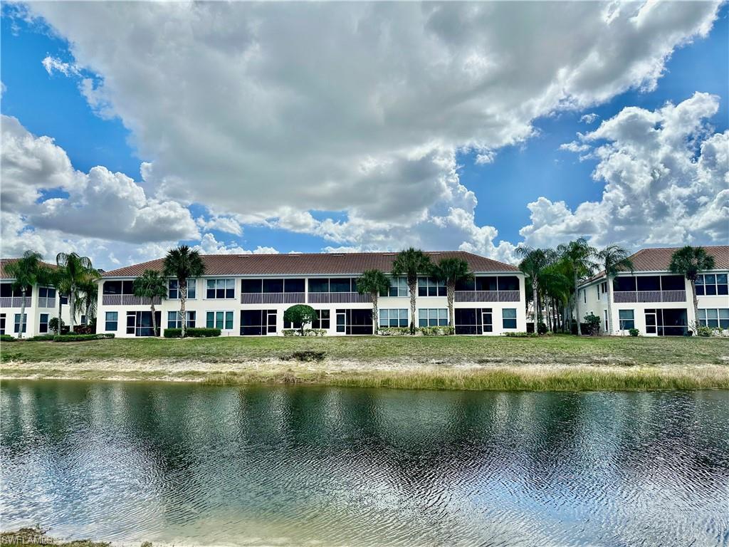 996 Hampton Circle, Unit 71 Naples, FL 34105 - Photo 23 of 30 a view of residential houses with yard and lake view