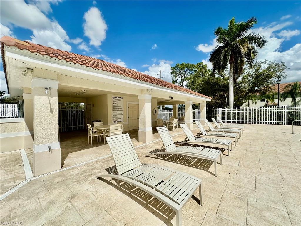 996 Hampton Circle, Unit 71 Naples, FL 34105 - Photo 28 of 30 a view of a patio with swimming pool table and chairs