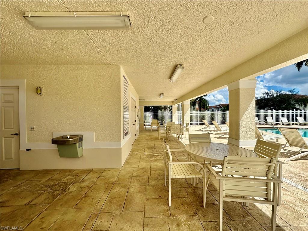996 Hampton Circle, Unit 71 Naples, FL 34105 - Photo 30 of 30 a view of a patio with swimming pool
