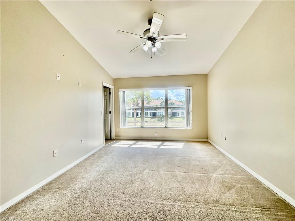 996 Hampton Circle, Unit 71 Naples, FL 34105 - Photo 10 of 30 an empty room with a ceiling fan and window