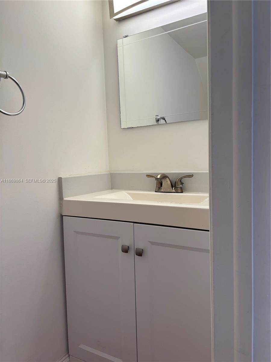4600 Southwest 67th Avenue, Unit 212 Miami, FL 33155 - Photo 11 of 21 a bathroom with a sink and a mirror