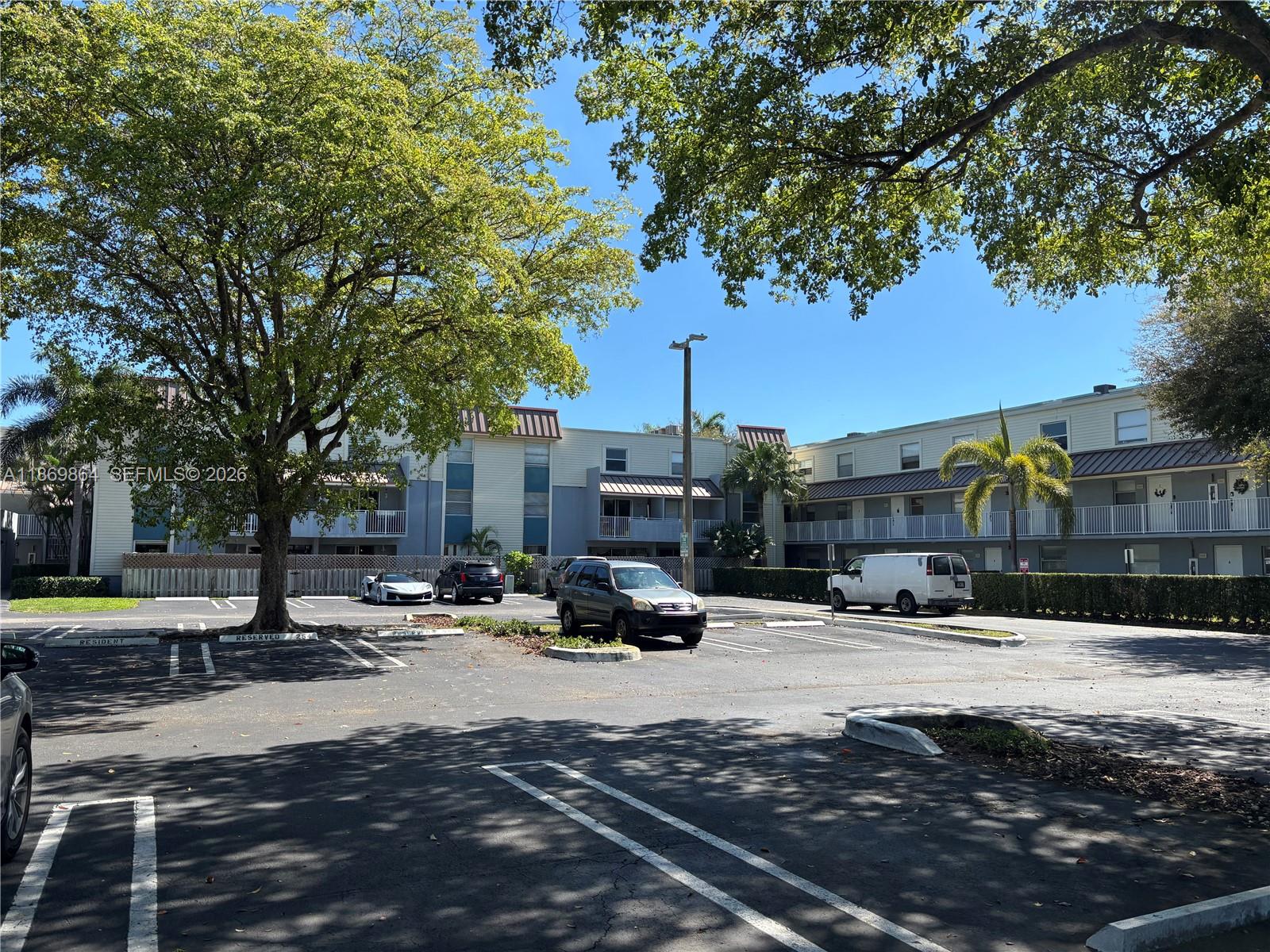 4600 Southwest 67th Avenue, Unit 212 Miami, FL 33155 - Photo 19 of 23 a building with trees in the background