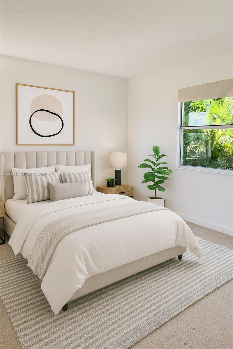 4600 Southwest 67th Avenue, Unit 212 Miami, FL 33155 - Photo 3 of 23 a bedroom with a bed and a window