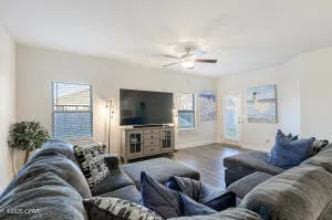 a living room with furniture and a ceiling fan