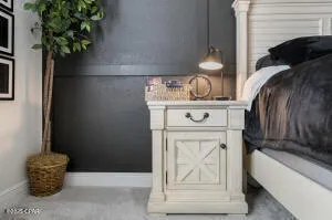 a bedroom with furniture and a flat screen tv