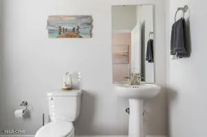 a view of staircase with railing and white walls