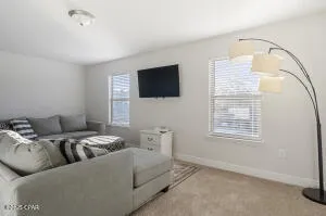 a view of a livingroom with workspace and a window