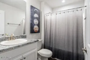 a bedroom with a bed a tv and next to a window