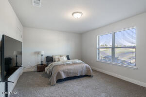 113 Ridgeway Circle Crestview, FL 32536 - Photo 42 of 55 a bedroom with a bed a tv and next to a window