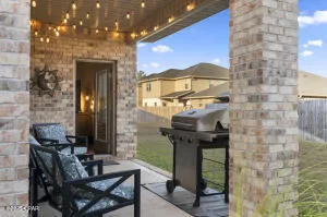 a backyard of a house with table and chairs