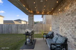 a backyard of a house with table and chairs