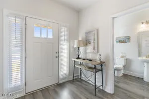 a kitchen with stainless steel appliances a sink a stove a refrigerator cabinets and a window