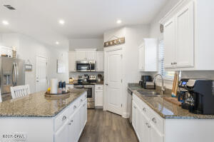 113 Ridgeway Circle Crestview, FL 32536 - Photo 10 of 55 a kitchen with stainless steel appliances granite countertop a sink stove and refrigerator