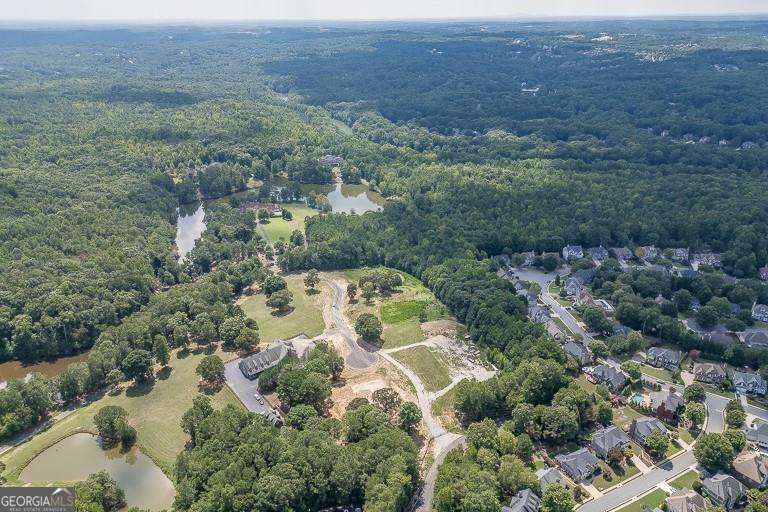 5755 Kennedy Road Buford, GA 30024 - Photo 16 of 23 an aerial view of house with yard and mountain view in back