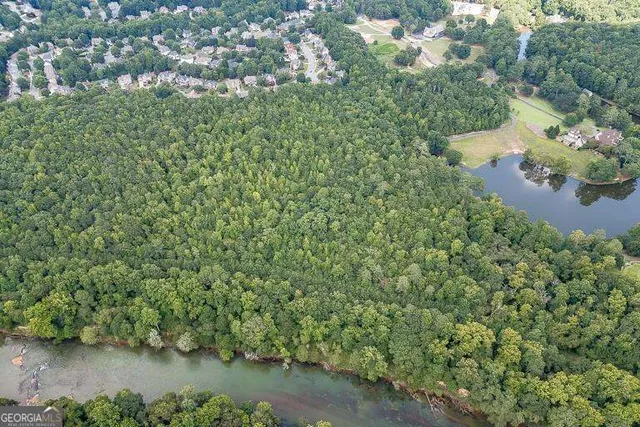 an aerial view of residential house with outdoor space and swimming pool