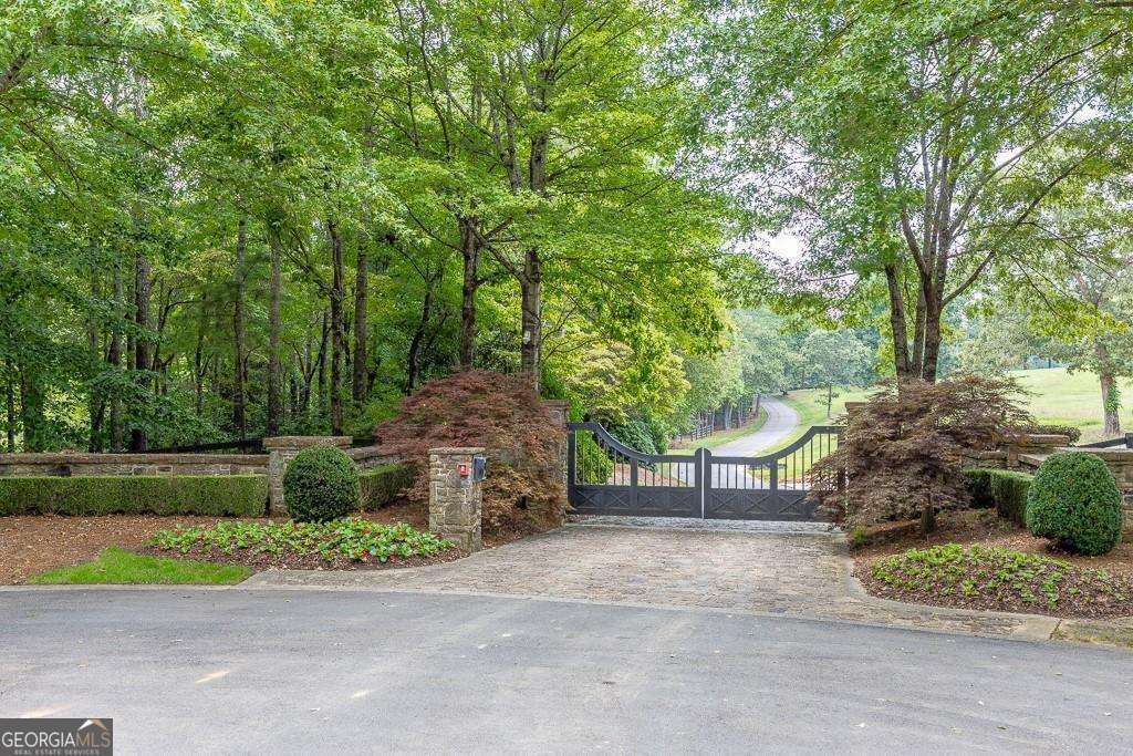5755 Kennedy Road Buford, GA 30024 - Photo 3 of 23 a view of a street with a bench and some trees