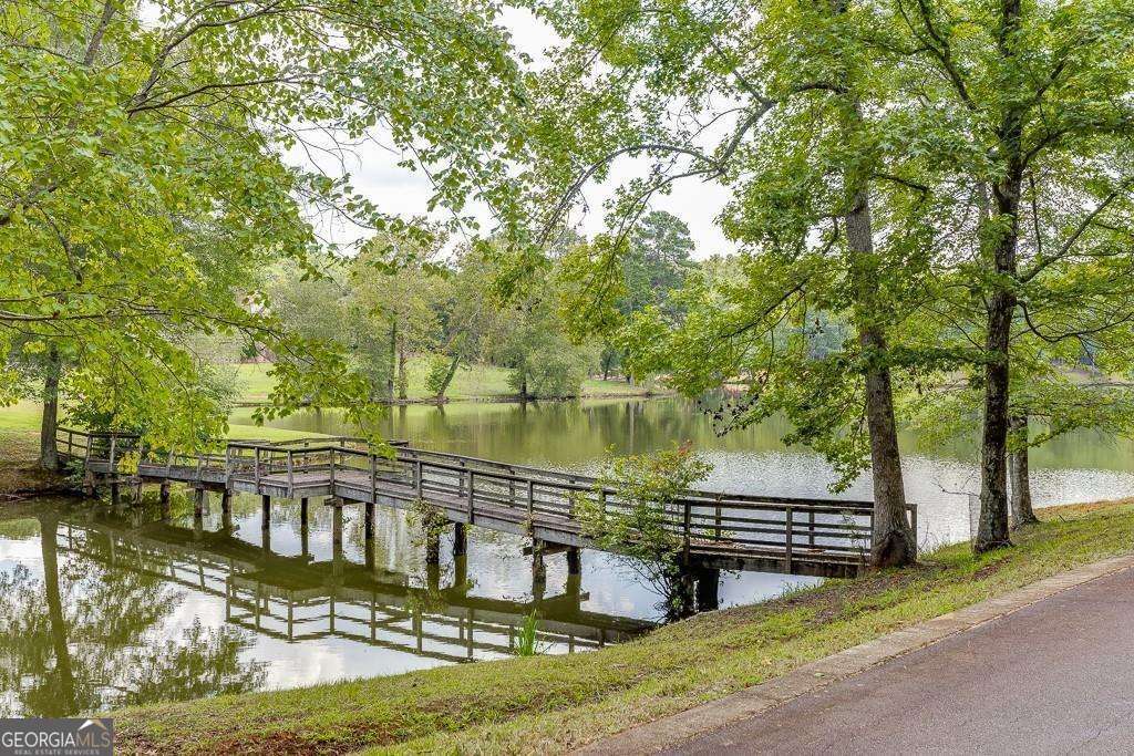 5755 Kennedy Road Buford, GA 30024 - Photo 4 of 23 a view of a lake with a house in the background