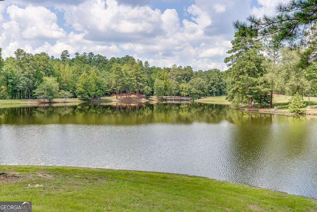 5755 Kennedy Road Buford, GA 30024 - Photo 8 of 23 a view of a lake with houses in the back