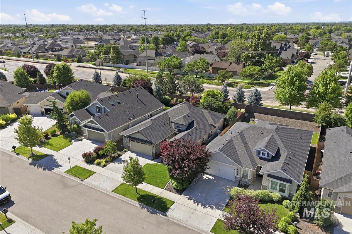 1303 West Brando Street Meridian, ID 83646 - Photo 41 of 49 Residential street with multiple properties featuring asphalt shingle roofs and established landscaping