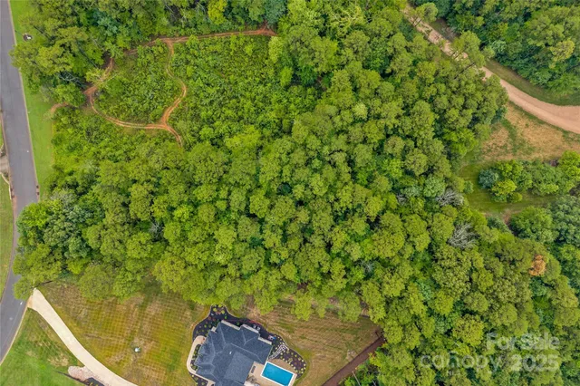 a backyard of a house with lots of green space and garden