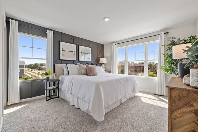 a bed room with a bed and a large window