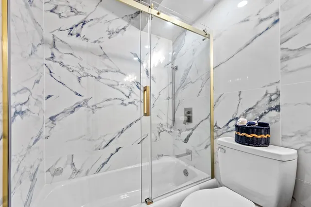 a bathroom with a toilet and a shower