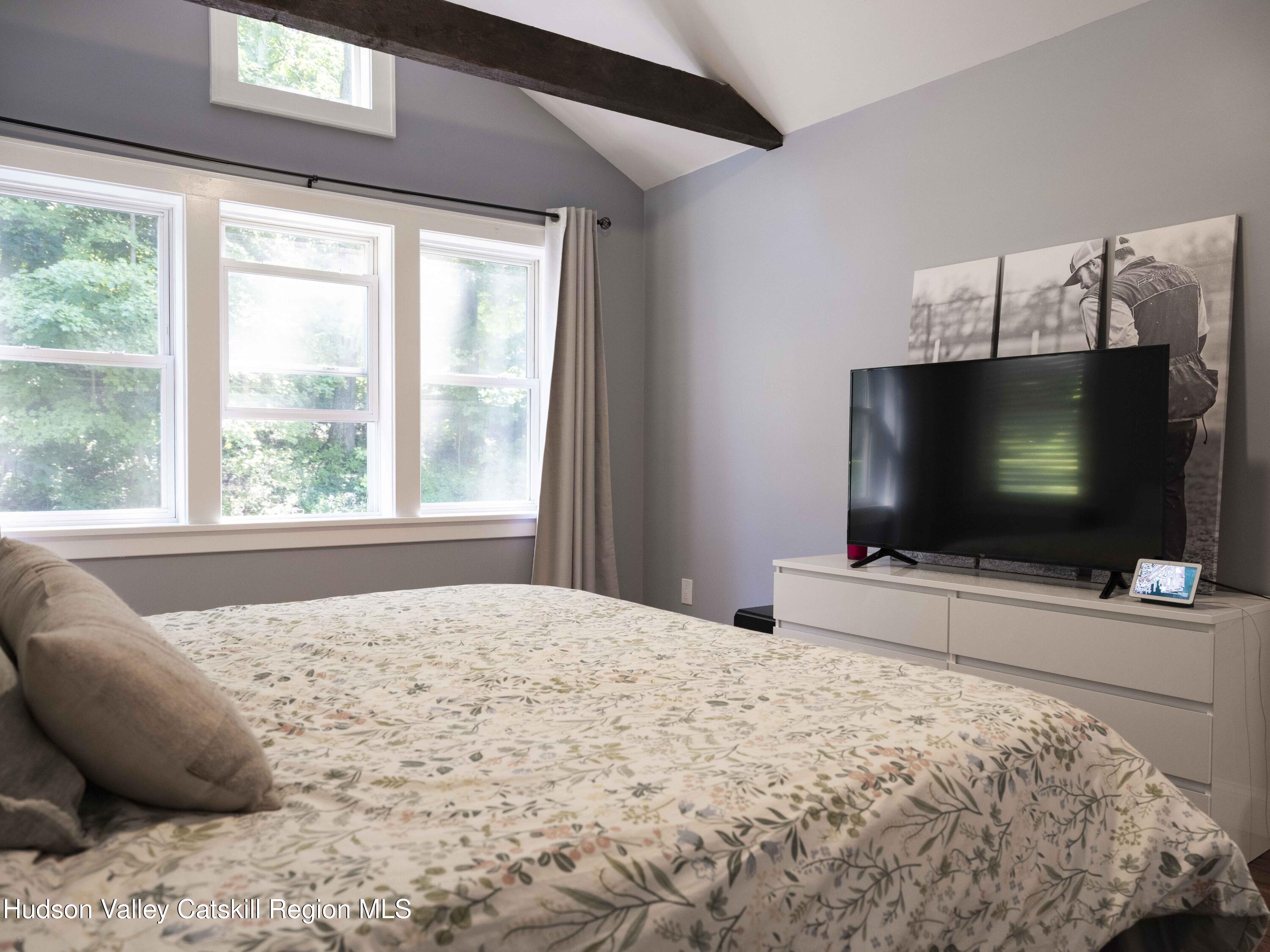 159 Ketchamtown Road Wappingers Falls, NY 12590 - Photo 15 of 31 a bedroom with a bed and a flat screen tv