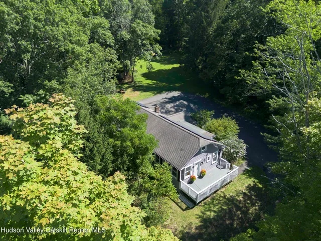 an aerial view of a house with a yard