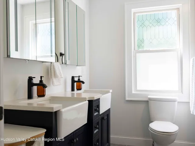 a kitchen with a sink cabinets and a window