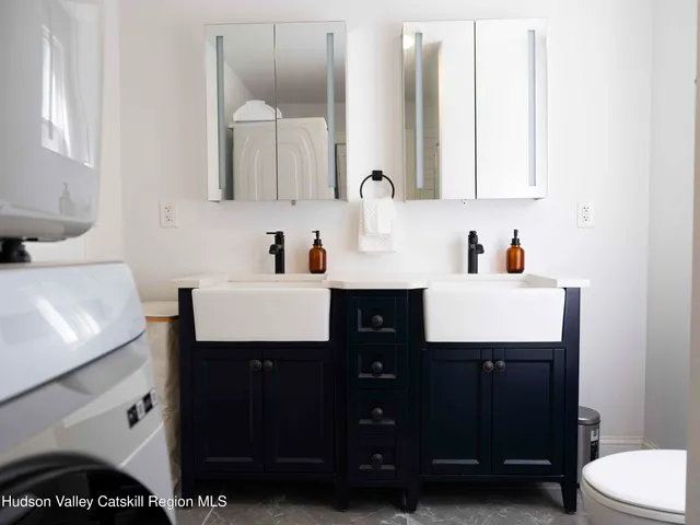 a bathroom with a sink vanity and a mirror
