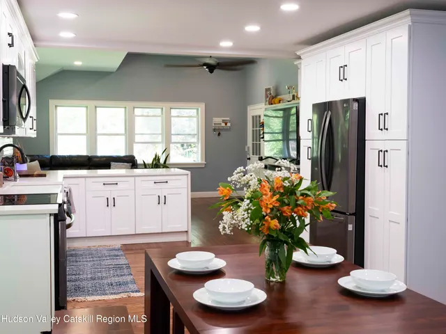 a kitchen with stainless steel appliances kitchen island granite countertop a refrigerator and a stove