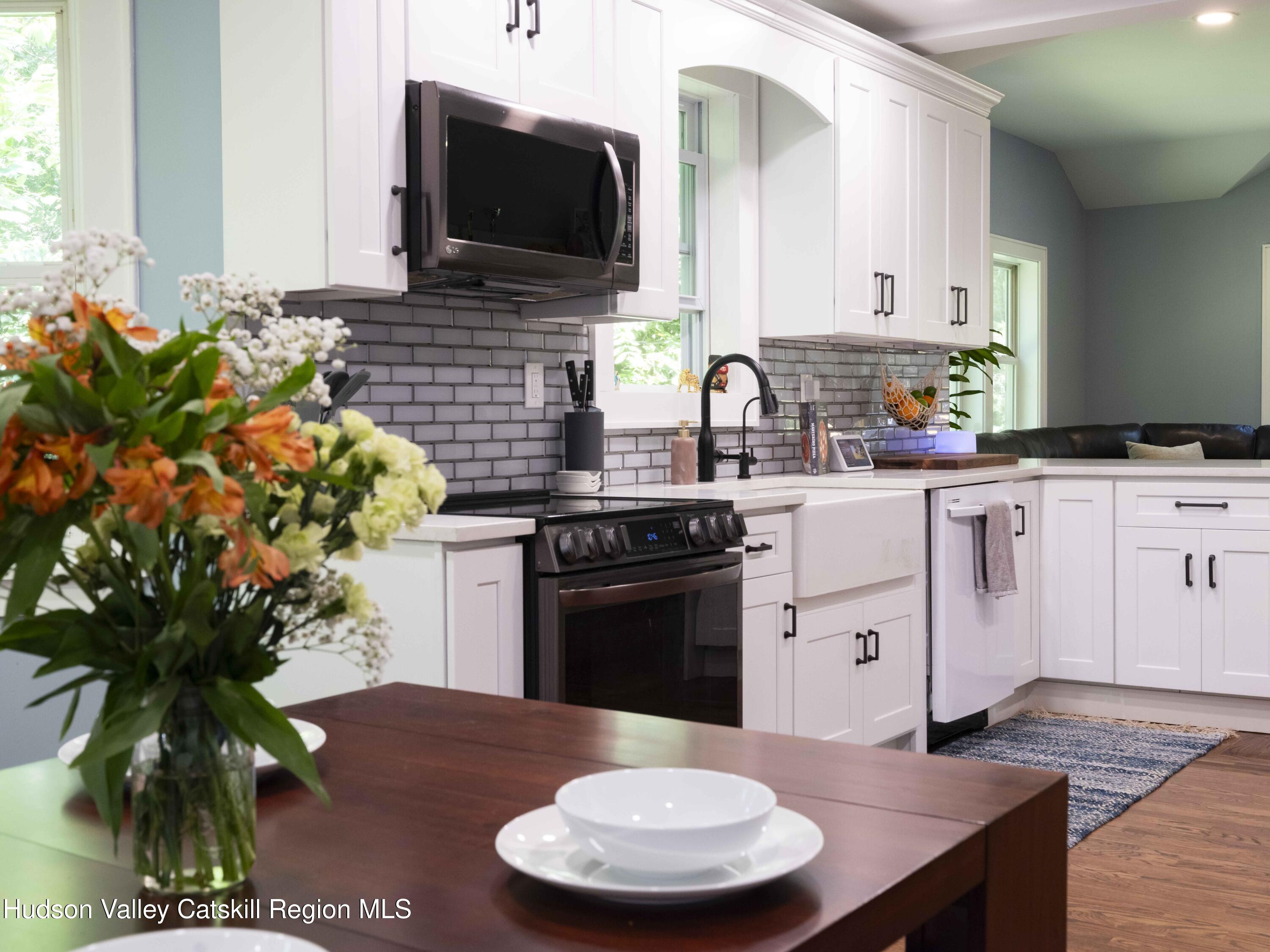 159 Ketchamtown Road Wappingers Falls, NY 12590 - Photo 6 of 31 a kitchen with stainless steel appliances a sink a stove a microwave a sink and cabinets