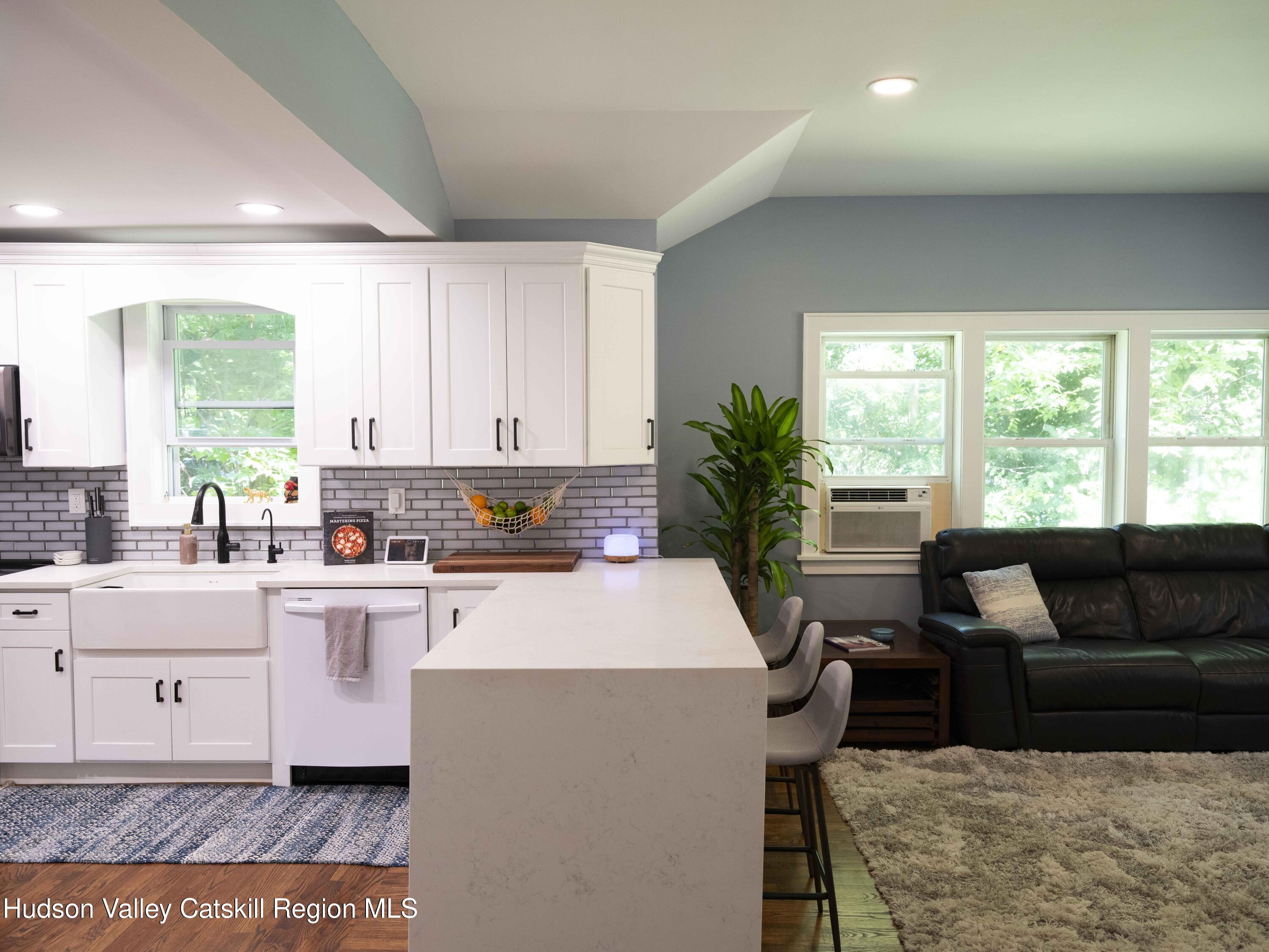 159 Ketchamtown Road Wappingers Falls, NY 12590 - Photo 10 of 31 a kitchen with kitchen island granite countertop a sink and white cabinets