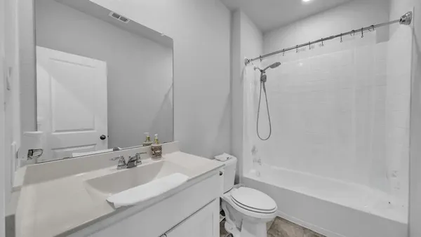 a bathroom with a sink toilet tub and shower