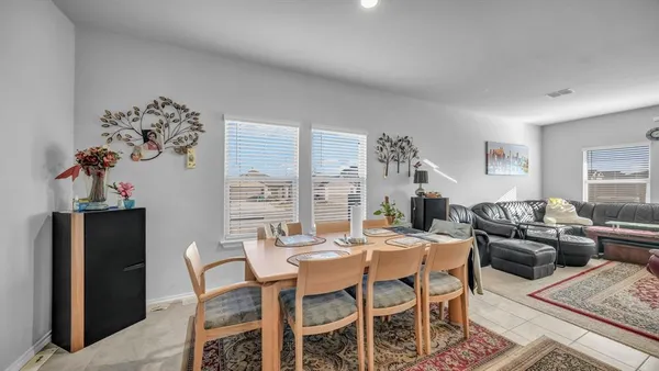 a dining room with furniture a rug and a chandelier