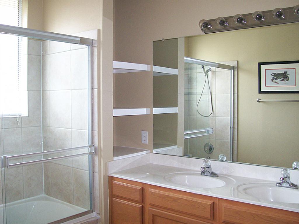 811 Bradford Avenue, Unit 5B Kemah, TX 77565 - Photo 14 of 22 a bathroom with a shower sink and mirror