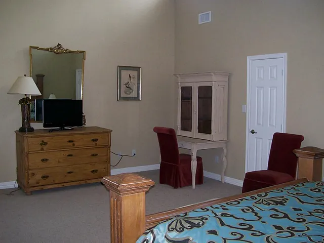 a bedroom with furniture and a window