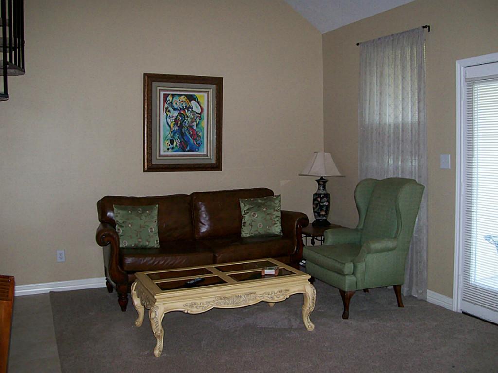 811 Bradford Avenue, Unit 5B Kemah, TX 77565 - Photo 5 of 22 a living room with furniture and a window