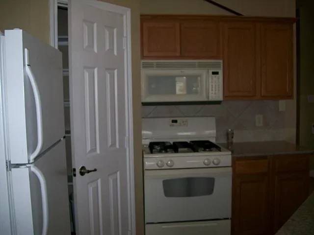a kitchen with a stove and a microwave