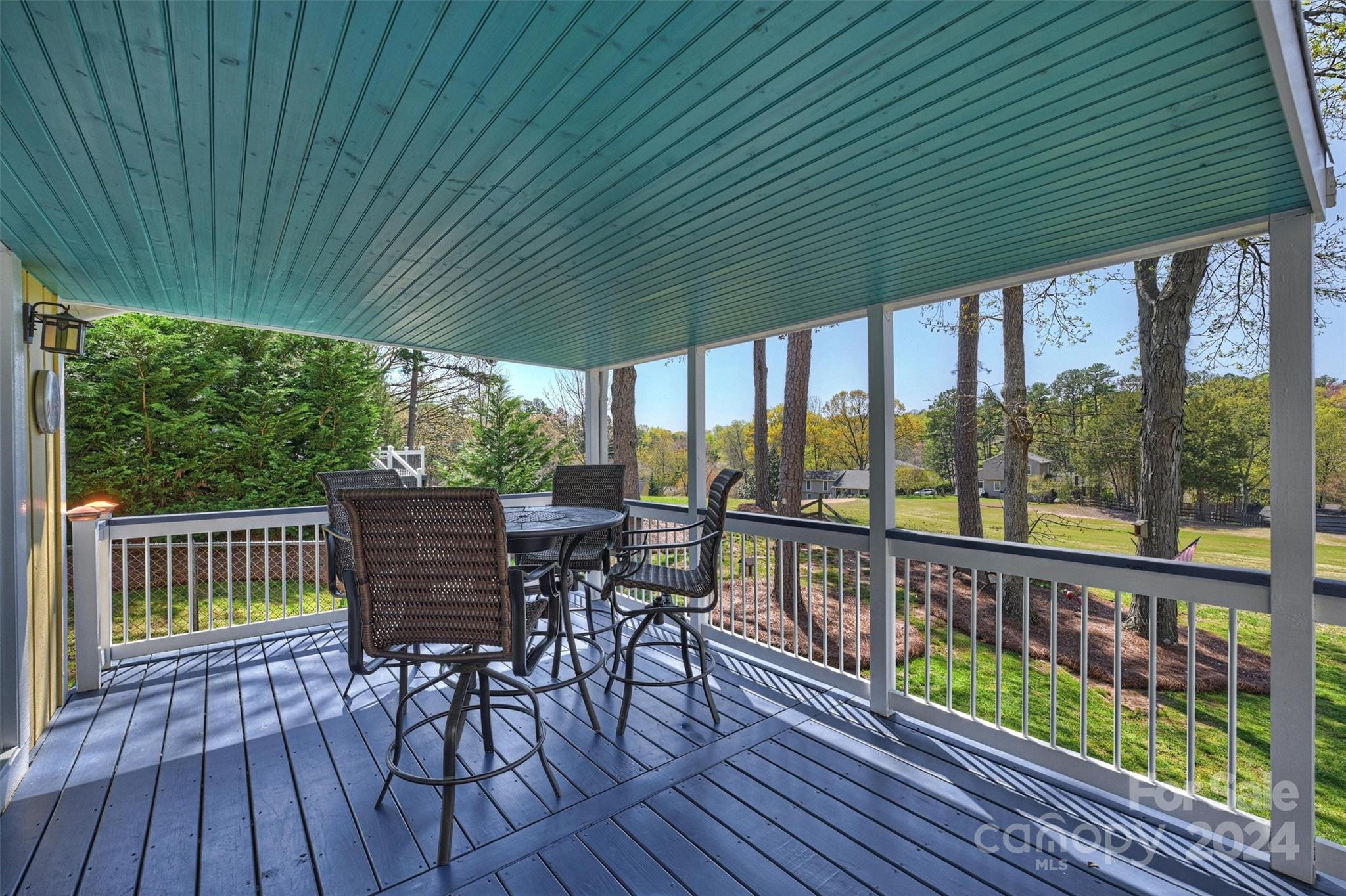 1190 Molokai Drive Tega Cay, SC 29708 - Photo 29 of 46 a patio with wooden floor a yard tables and chairs