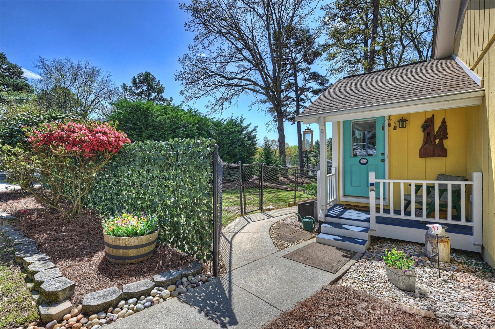 1190 Molokai Drive Tega Cay, SC 29708 - Photo 34 of 46 a view of a patio with furniture and a garden