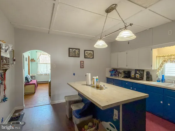 a kitchen with a sink a counter top space stainless steel appliances and cabinets