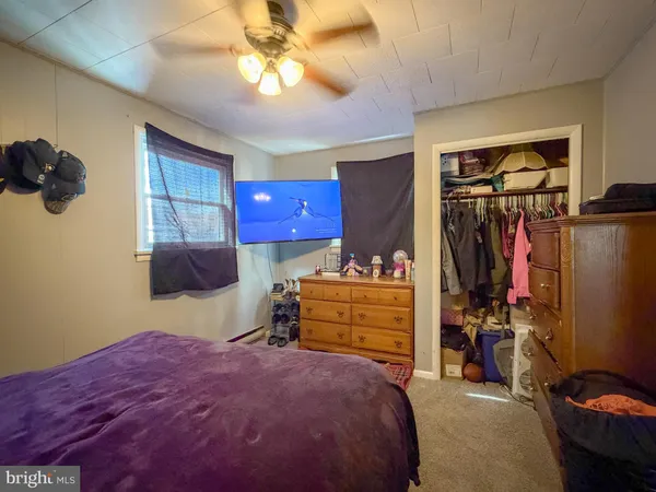 a bedroom with a bed a couch and a window