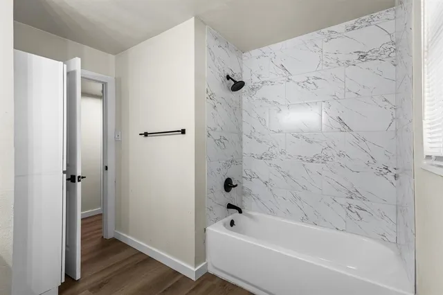 a bathroom with a bathtub and a shower