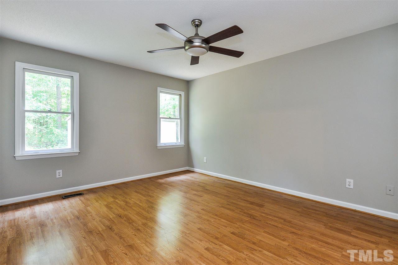 5208 Relay Way Raleigh, NC 27603 - Photo 13 of 25 a view of empty room with wooden floor and fan