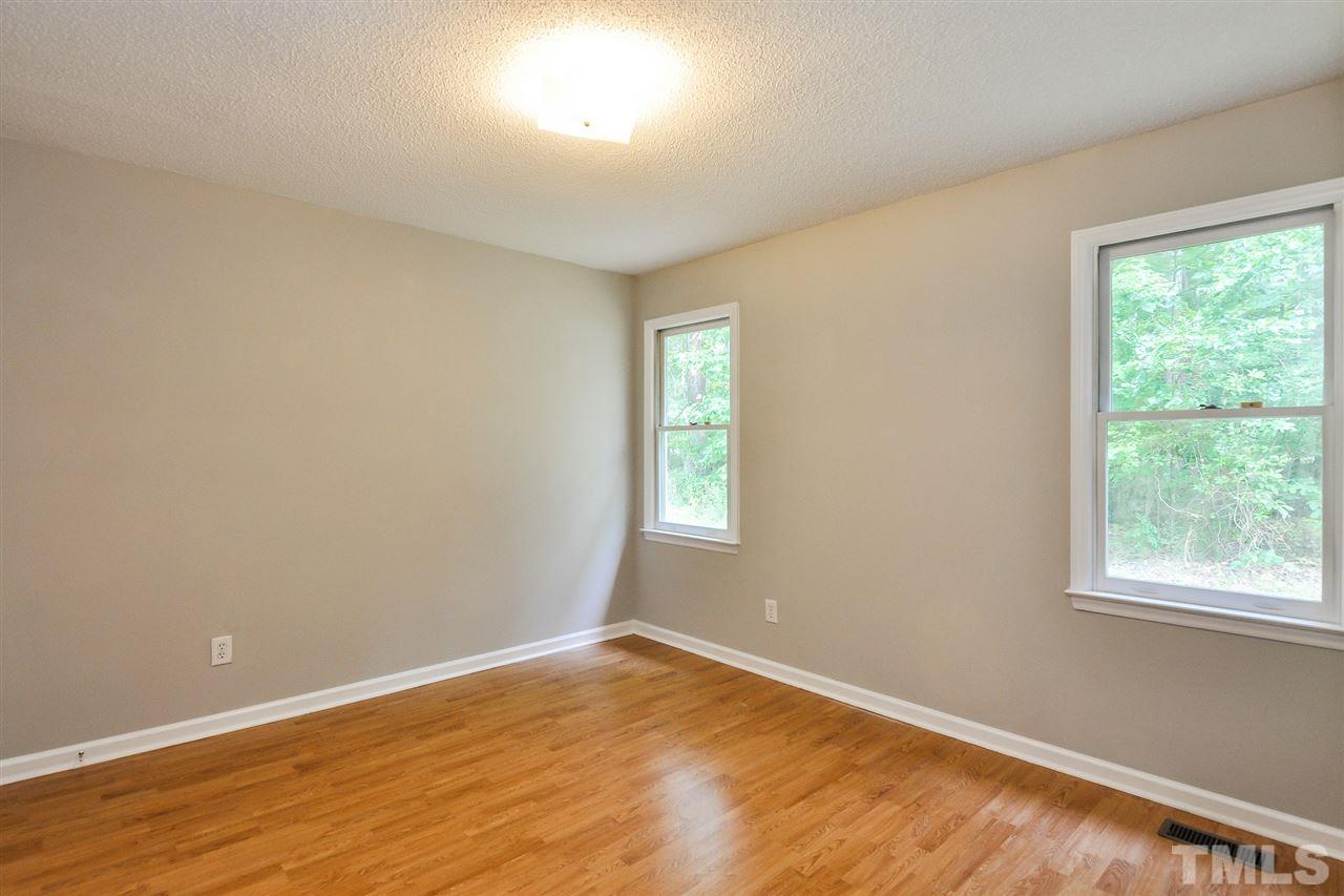 5208 Relay Way Raleigh, NC 27603 - Photo 17 of 25 a view of an empty room with wooden floor and a window