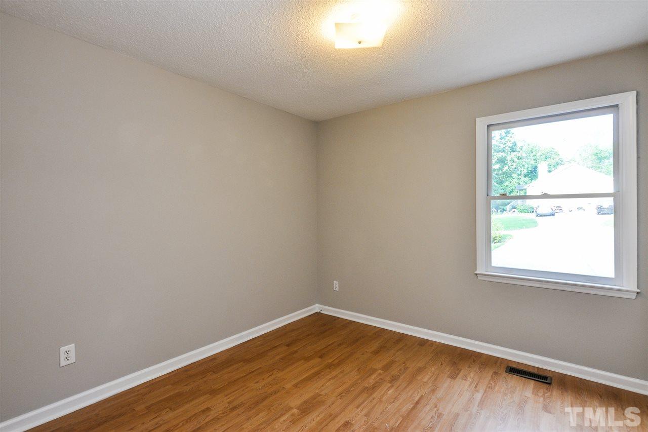 5208 Relay Way Raleigh, NC 27603 - Photo 18 of 25 an empty room with wooden floor and windows