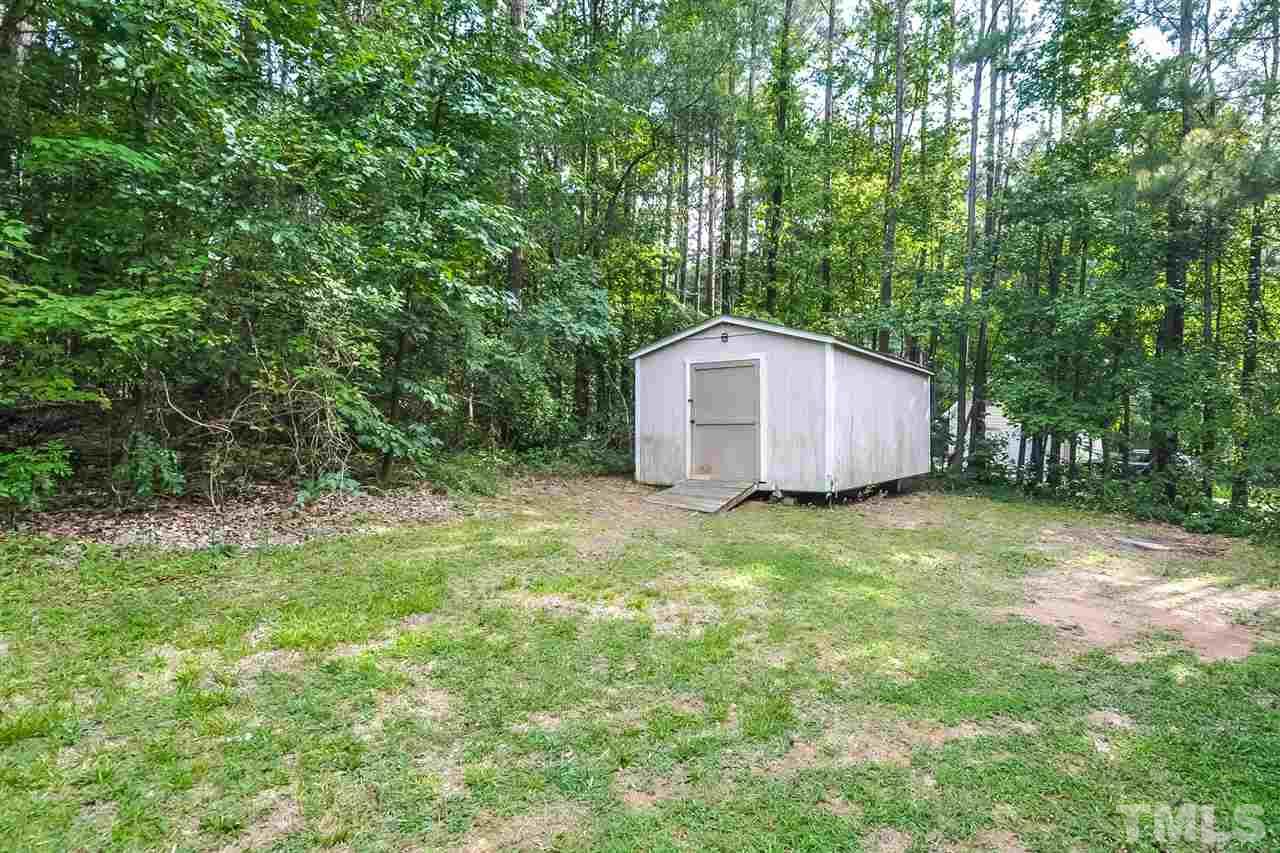 5208 Relay Way Raleigh, NC 27603 - Photo 24 of 25 a backyard of a house with plants and large trees