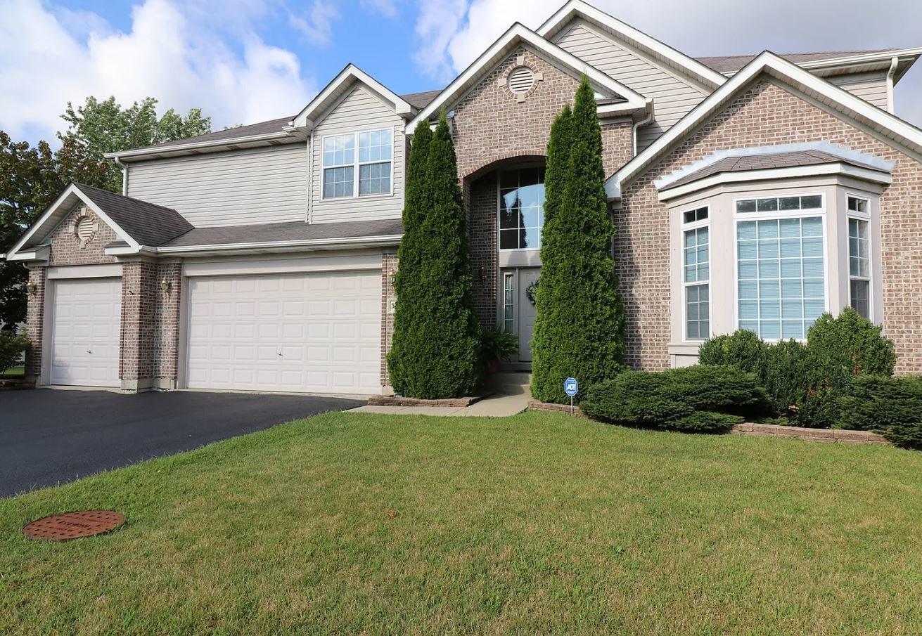 37076 North Bonnie Brae Road Lake Villa, IL 60046 - Photo 1 of 17 a front view of a house with a yard and garage